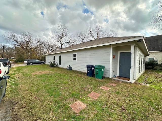 back of house with a lawn