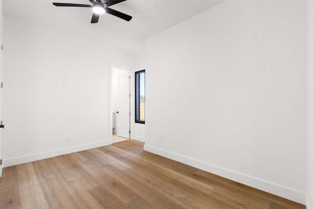 unfurnished room featuring light wood finished floors, ceiling fan, and baseboards