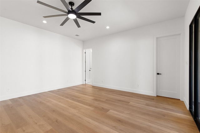 empty room featuring a ceiling fan, recessed lighting, light wood-style flooring, and baseboards