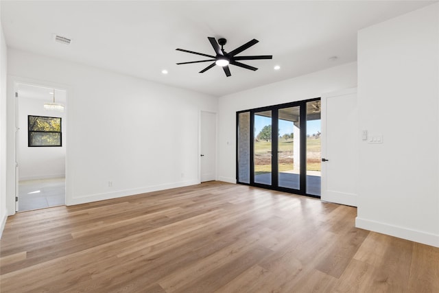 unfurnished room with light wood-type flooring, visible vents, baseboards, and recessed lighting