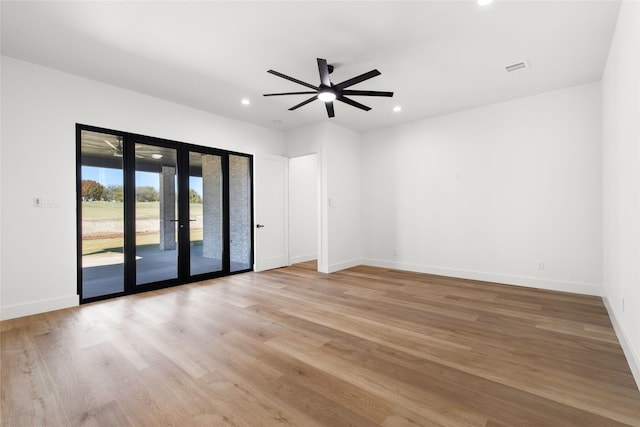 unfurnished room featuring light wood finished floors, baseboards, a ceiling fan, french doors, and recessed lighting