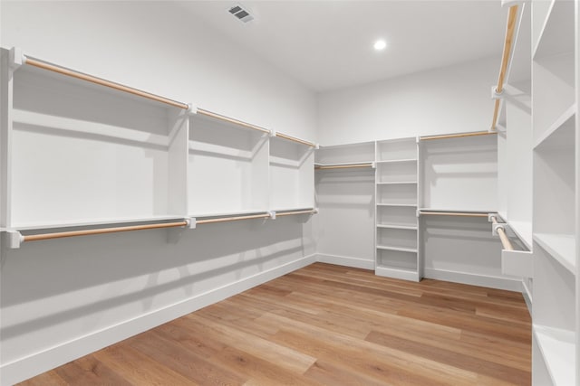 walk in closet featuring visible vents and wood finished floors