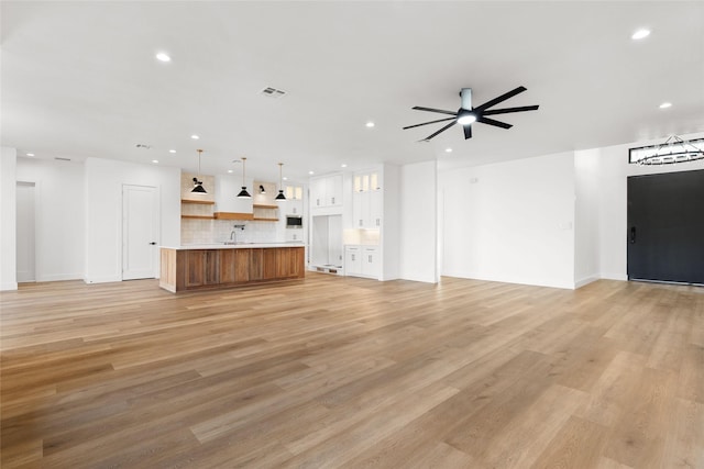 unfurnished living room featuring light wood-style floors, visible vents, and recessed lighting