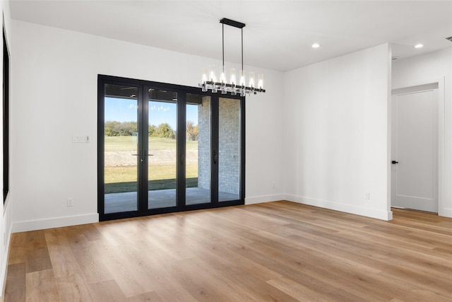 unfurnished dining area with light wood-type flooring, baseboards, and recessed lighting