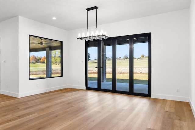 spare room featuring light wood-style flooring and baseboards