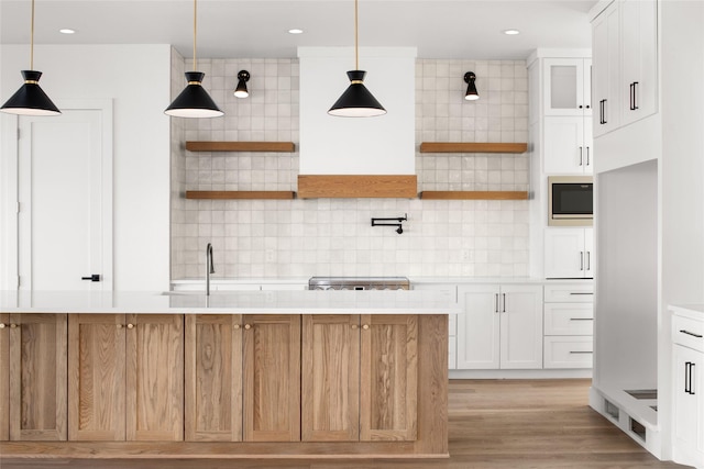 kitchen featuring built in microwave, open shelves, and decorative backsplash