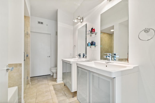 bathroom with tile patterned flooring, vanity, toilet, and a shower with shower door