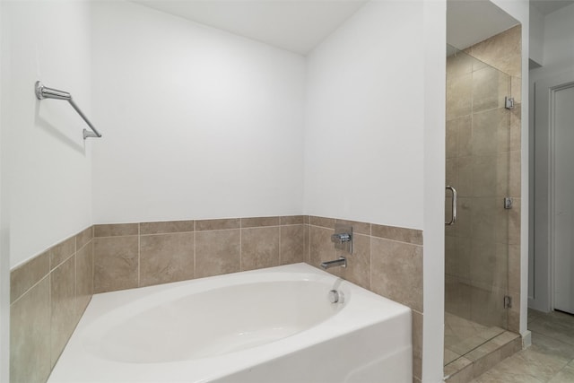 bathroom with tile patterned floors and independent shower and bath