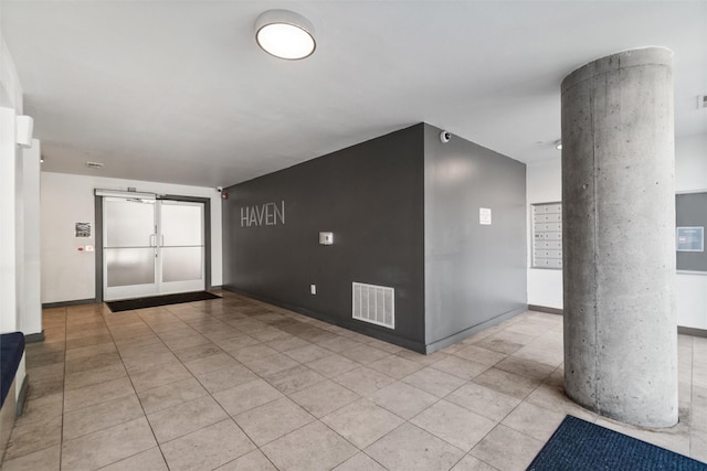 entryway featuring mail boxes and light tile patterned floors