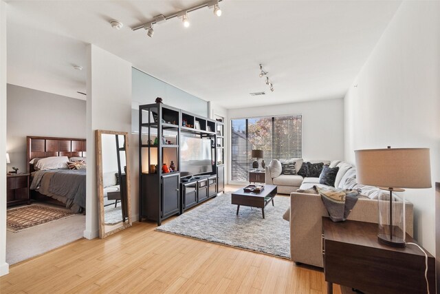 kitchen featuring white cabinets, light wood-type flooring, and stainless steel appliances