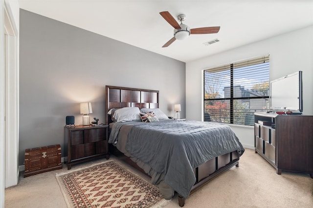 bedroom with ceiling fan and light carpet