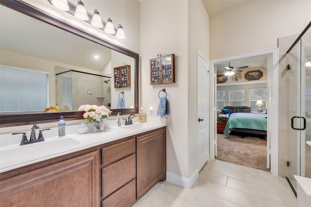 bathroom featuring ceiling fan, tile patterned floors, a shower with door, and vanity