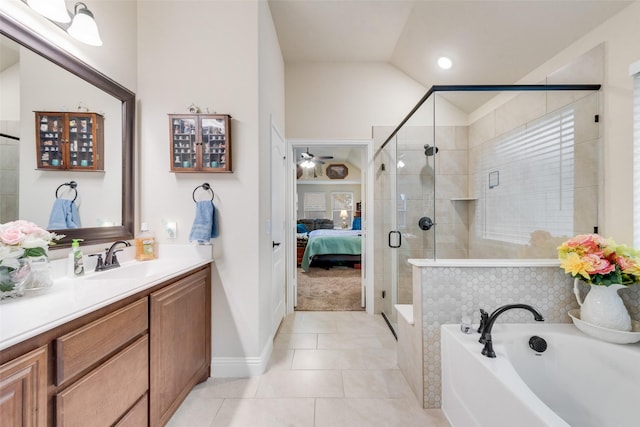 bathroom featuring independent shower and bath, lofted ceiling, tile patterned flooring, vanity, and ceiling fan