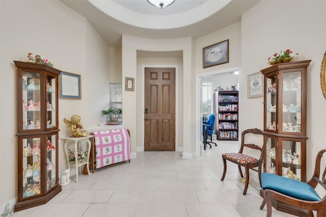 tiled entrance foyer with a towering ceiling