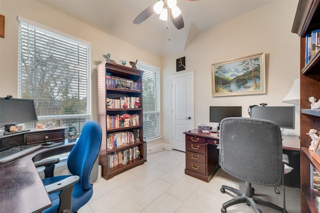 tiled home office featuring vaulted ceiling and ceiling fan