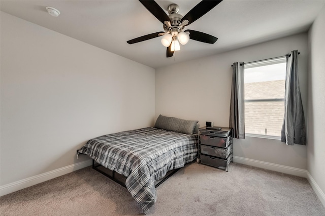 bedroom with ceiling fan and light colored carpet