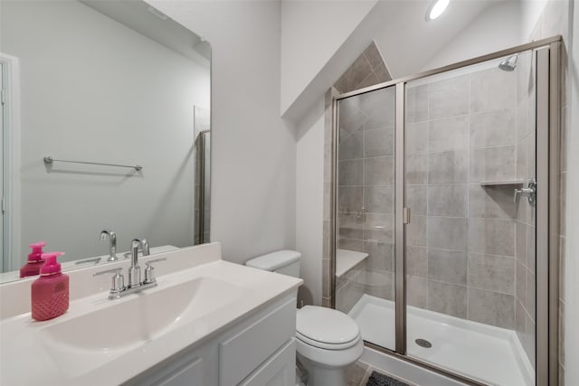 bathroom featuring vanity, toilet, and a shower with door