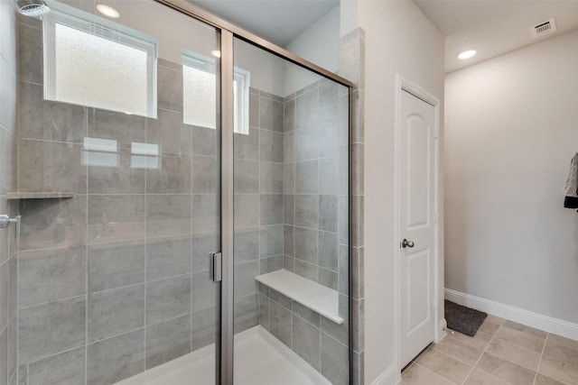 bathroom with tile patterned flooring and an enclosed shower