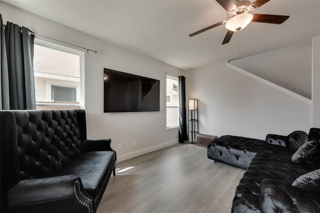 living room with light hardwood / wood-style floors and ceiling fan