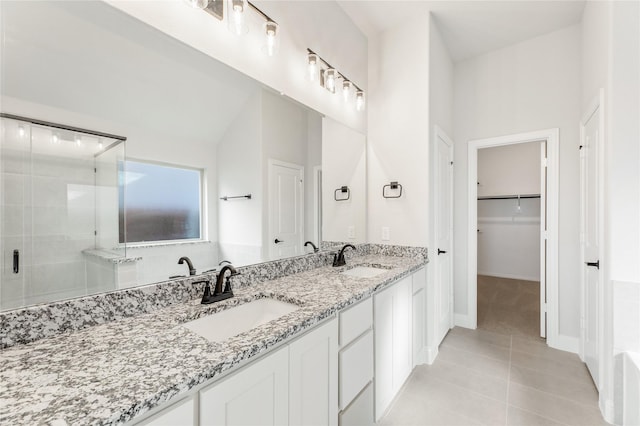 bathroom featuring an enclosed shower, vanity, tile patterned floors, and lofted ceiling