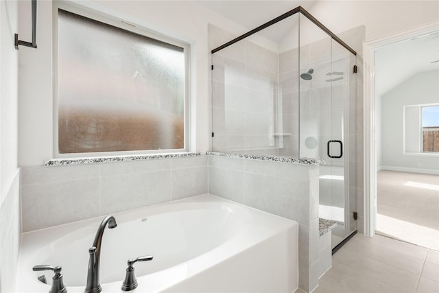 bathroom with tile patterned floors, lofted ceiling, and plus walk in shower