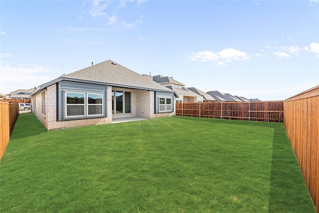 rear view of property featuring a yard