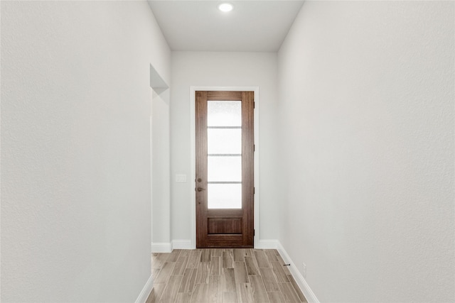 doorway to outside with light wood-type flooring