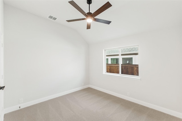 carpeted empty room with ceiling fan and vaulted ceiling