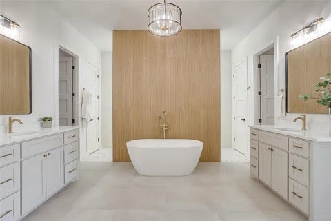 192 Top Flight Dr, Weatherford, TX 76087 - bathroom featuring a sink, a freestanding bath, and two vanities