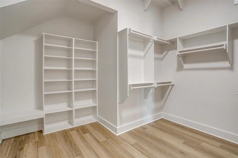 192 Top Flight Dr, Weatherford, TX 76087 - walk in closet with vaulted ceiling and wood finished floors