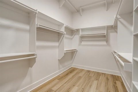 192 Top Flight Dr, Weatherford, TX 76087 - spacious closet featuring wood finished floors