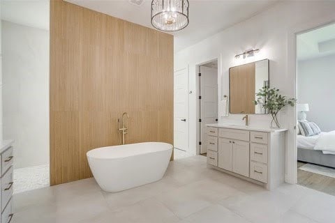 192 Top Flight Dr, Weatherford, TX 76087 - ensuite bathroom with vanity, a freestanding tub, ensuite bathroom, and a notable chandelier