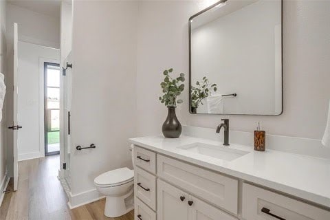 192 Top Flight Dr, Weatherford, TX 76087 - bathroom featuring vanity, wood finished floors, and toilet