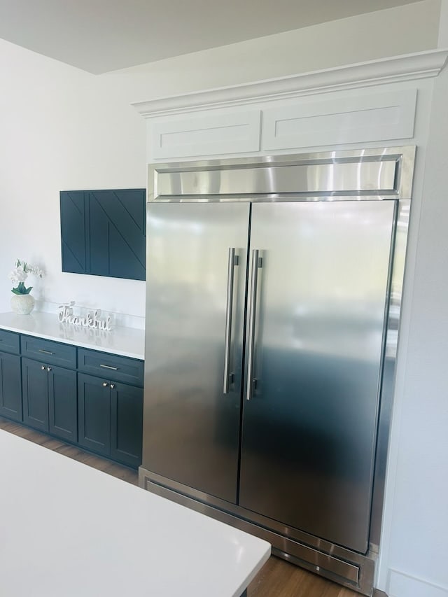 192 Top Flight Dr, Weatherford, TX 76087 - kitchen featuring light countertops, built in refrigerator, dark wood finished floors, and blue cabinets