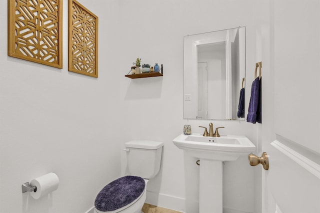 bathroom featuring toilet and sink