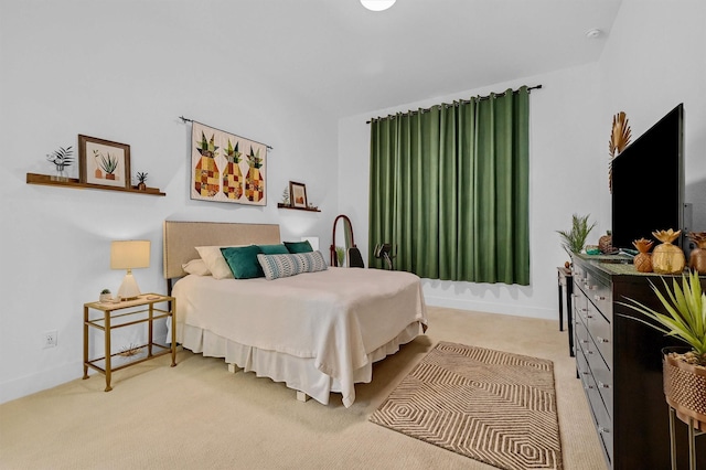 bedroom featuring light carpet