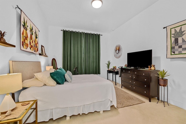 carpeted bedroom with lofted ceiling