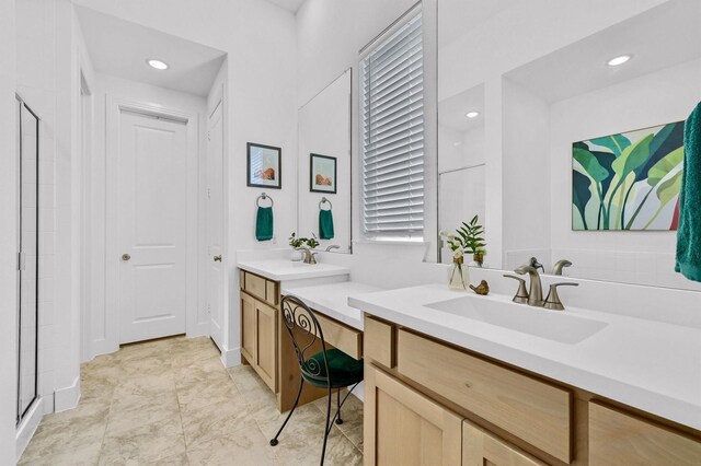 bathroom with vanity and a shower with shower door