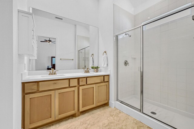 bathroom featuring vanity, ceiling fan, and a shower with shower door