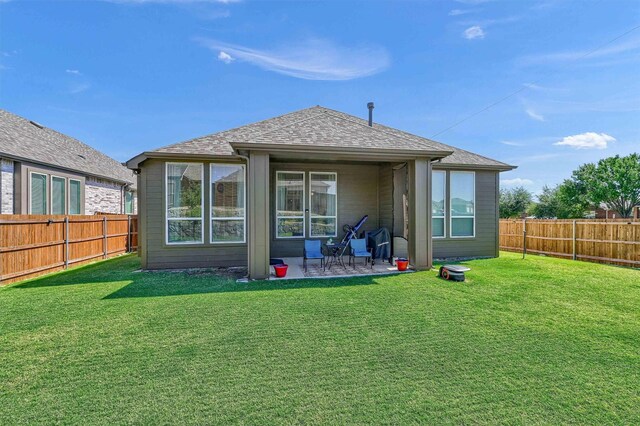 back of property with a lawn and a patio