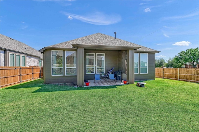 rear view of house with a yard and a patio area