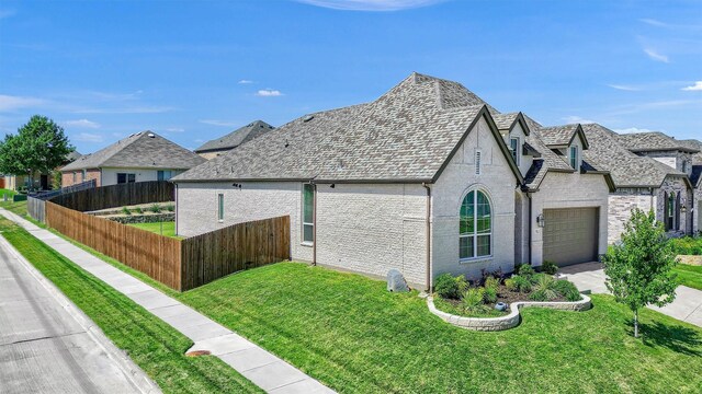 view of side of property with a garage and a lawn