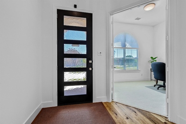 entryway with hardwood / wood-style floors