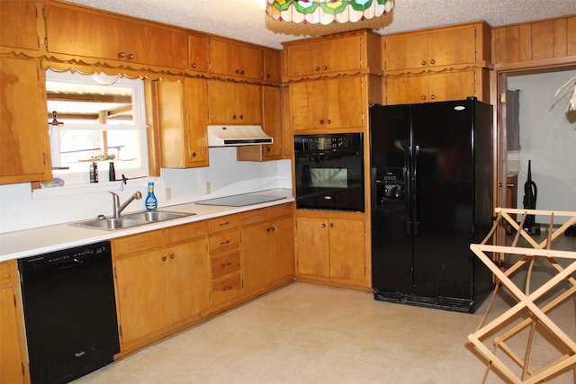 kitchen featuring black appliances, sink, and a textured ceiling