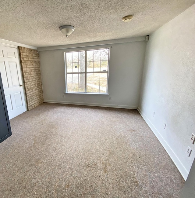 carpeted spare room with a textured ceiling