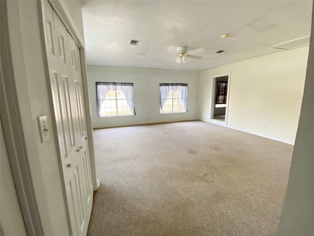 spare room featuring ceiling fan and light colored carpet