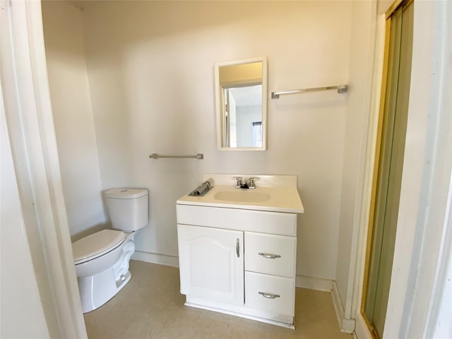 bathroom featuring tile patterned floors, vanity, and toilet