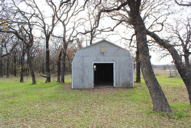 view of outbuilding featuring a lawn