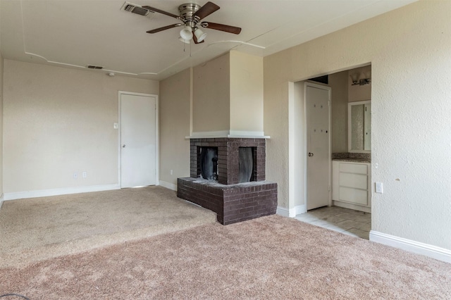 unfurnished living room featuring light carpet, ceiling fan, and a fireplace