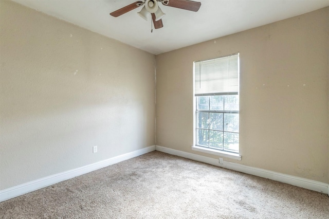 carpeted empty room with ceiling fan and a healthy amount of sunlight